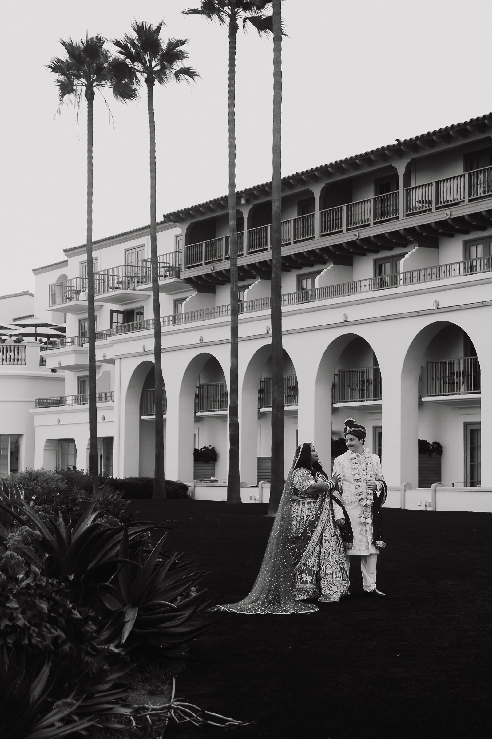 A black and white portrait of Lakshmi and Isaac at their wedding